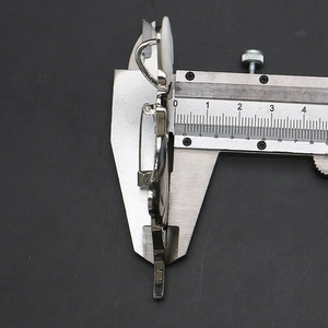Measuring the 10mm side thickness of the silver shell brooch using a vernier caliper