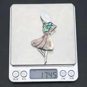 Detail of a dancer brooch weighing 17.45g with rainbow abalone shell and mother of pearl