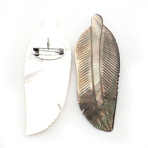 Iridescent natural shell feather brooch with dual-sided detail and metallic pin clasp
