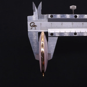 Detail view of pink stone pendant showing 7.2mm thickness and gold-plated bezel