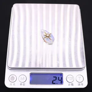 Waterdrop pendant weighing 2.4g on a digital scale showing weight for DIY jewelry