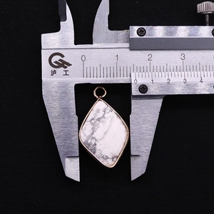 Detailed macro view showing the 16mm width of the diamond-shaped marble stone pendant