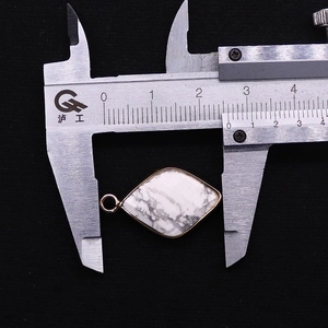 Detailed measurement of diamond-shaped white marble stone pendant with gold plated edges