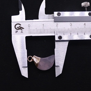 Macro shot of 1.8cm crescent moon faceted gemstone pendant measured by a caliper