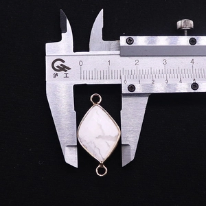 Rhombus gemstone connector with gold trim measured at 18.5mm width on calipers