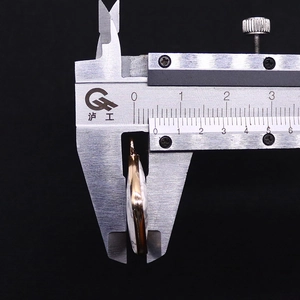 Detail view showing thickness measurement of natural white stone pendant with gold plating
