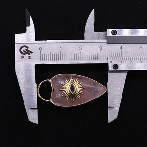 Detail showing natural rose quartz heart pendant width measured with a digital caliper