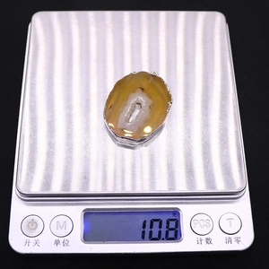 Detail shot of natural geode agate slice pendant with silver edge weighing 10.8 grams