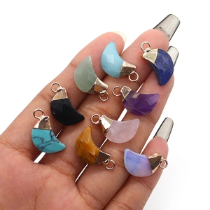 Faceted crescent moon gemstone pendants in various colors with golden metal bail
