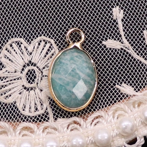 Detailed macro view of an oval turquoise stone pendant on elegant lace and pearls