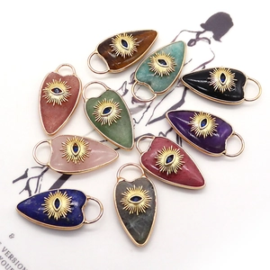 Collection of heart stone pendants featuring golden evil eye designs for DIY jewelry