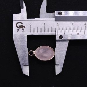 Detailed view of faceted oval rose quartz pendant measured with a digital caliper