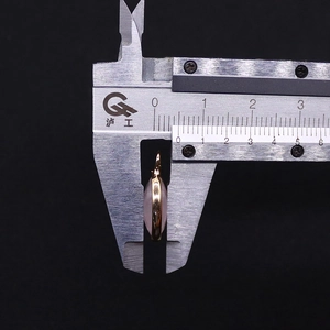 Detailed measurement of pink crystal oval pendant thickness showing gold plated bezel