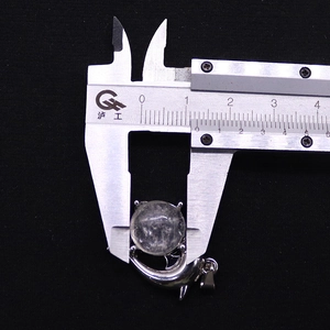 Macro view of 15.1mm natural stone whale pendant measured by a digital caliper