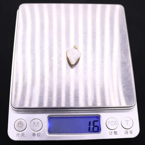 Detail shot of white shield stone pendant on electronic scale weighing 1.6g