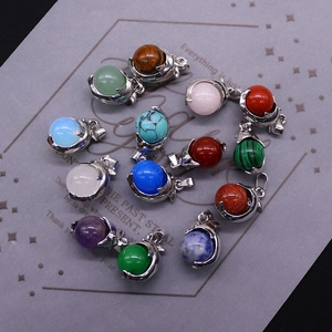 Natural crystal sphere pendants with dolphin metal holders in various gemstones