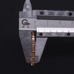 Detail view of the 1.5mm thickness measurement of the rose gold band with a caliper