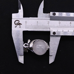 Detail showing 18mm width measurement of silver dolphin stone pendant with opal bead