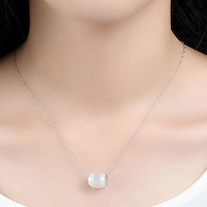 Elegant cat eye stone cylinder pendant necklace on a silver water wave chain for women