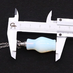 Detailed measurement of blue opal essential oil bottle necklace pendant using a caliper