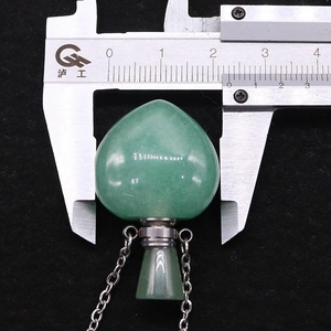 Detailed measurement of a heart-shaped green aventurine perfume bottle pendant using calipers