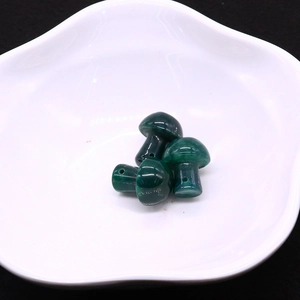 Detailed view of three green mushroom dragon vein agate beads with drill holes for DIY crafts