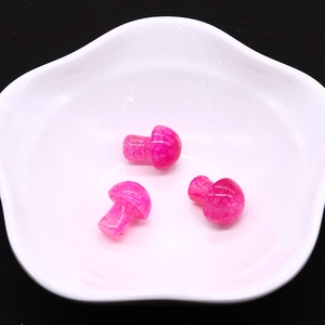 Detailed view of pink mushroom dragon vein agate stones in a white floral ceramic bowl