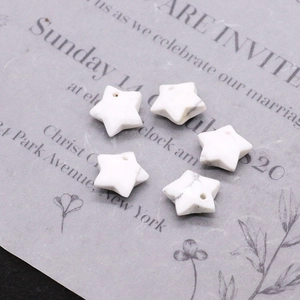Macro shot of star-shaped white turquoise stone beads with gray marble textures for DIY jewelry