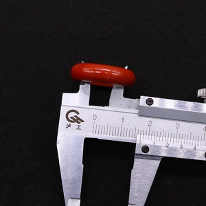 Macro view of natural red agate ring measured with calipers showing the outer diameter