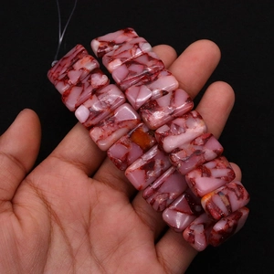 Macro detail of rectangular pink imperial stone beads with red marble veins for DIY jewelry