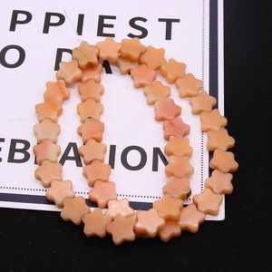 Macro shot of orange five-petal flower natural stone loose beads for DIY jewelry making