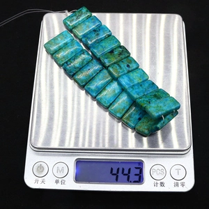 Nahaufnahme von natürlichen blau-grünen Jaspis-Perlen auf einer Waage mit 44,3 Gramm