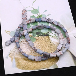 Macro view of blue imperial stone bone beads with natural marble patterns for jewelry DIY