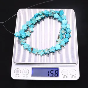Blue star-shaped turquoise stone beads showing a total weight of 15.8 grams on scale