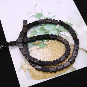 Flat bone-shaped imperial jasper loose beads in dark brown with gold speckle details