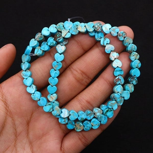 Macro detail of heart-shaped turquoise stone beads with natural brown mineral veins
