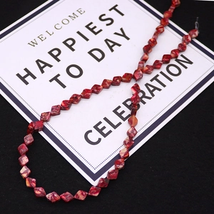 Macro shot of 6x8mm red imperial stone diamond beads with natural marble texture