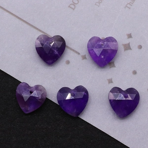 Macro detail of faceted purple crystal heart pendant with pre-drilled hole for DIY jewelry