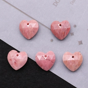 Detailed macro view of five faceted pink heart stone pendants for DIY necklace jewelry