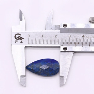 Detailed macro view of teardrop lapis lazuli stone with measurement on caliper