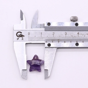 Measuring star-shaped amethyst crystal pendant with a digital caliper for 20mm size accuracy