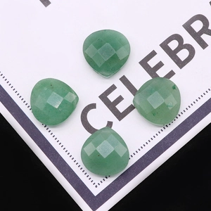 Macro-opname van vier groene aventurijn kralen in hartvorm voor DIY-sieraden