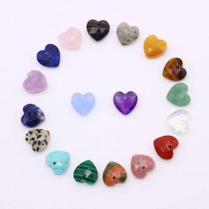 Polished faceted heart-shaped natural stone pendants arranged in a heart for DIY jewelry