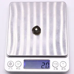 Detailed view of faceted gemstone on scale showing 2.0g weight for jewelry making