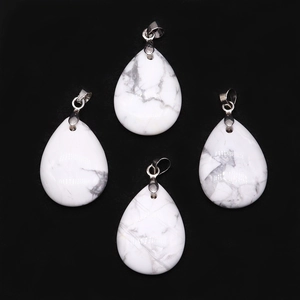 Macro view of teardrop white howlite stone pendants with natural grey veining detail