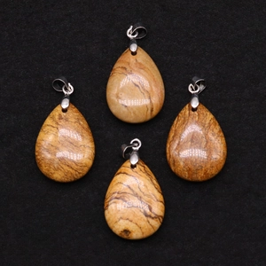 Macro detail of four teardrop-shaped natural picture jasper stone pendants with silver clasps