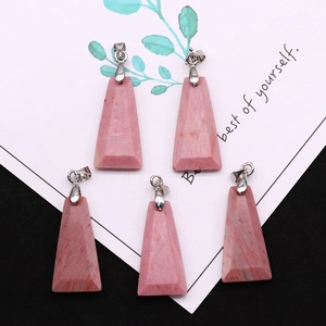 Macro view of five pink natural stone trapezoid pendants with silver metal clasps