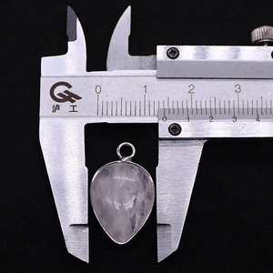 Measuring a 1.8cm teardrop-shaped natural stone pendant with a silver metal frame