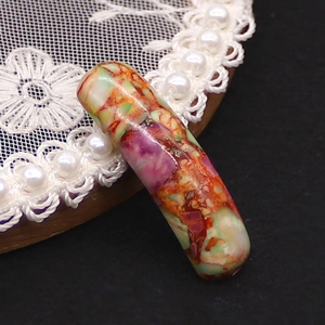 Macro shot of polished colorful natural stone cylindrical tube bead for DIY jewelry making