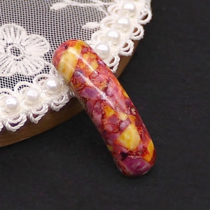 Macro shot of mosaic stone tube connector with colorful marble patterns for DIY jewelry